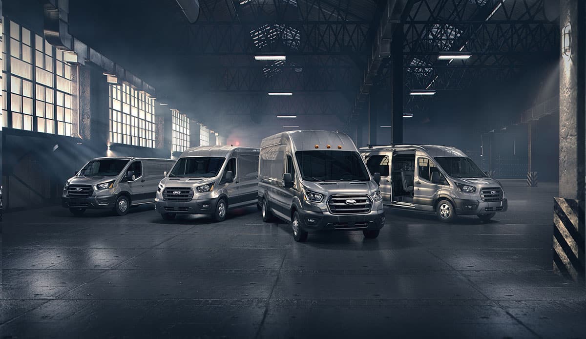 Four 2020 Ford Transits are displayed in a warehouse, ready for work.