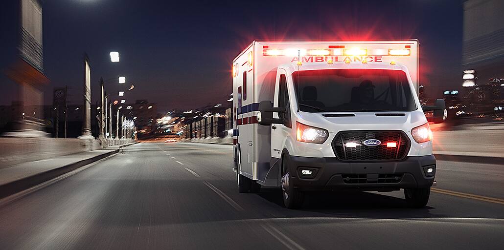A 2020 Ford Transit ambulance rushing to an emergency.