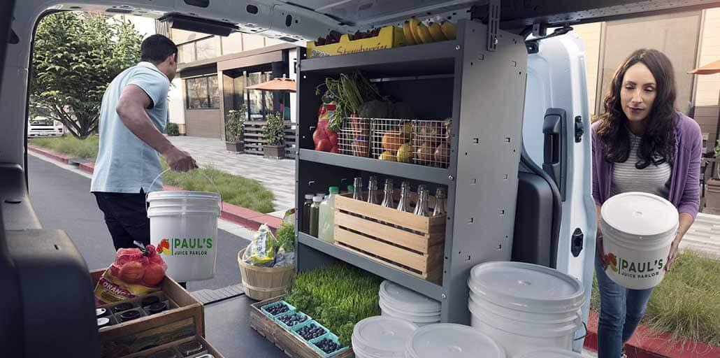 Ford Transit Connect with racks and bins holding fruits, vegetables and bottles