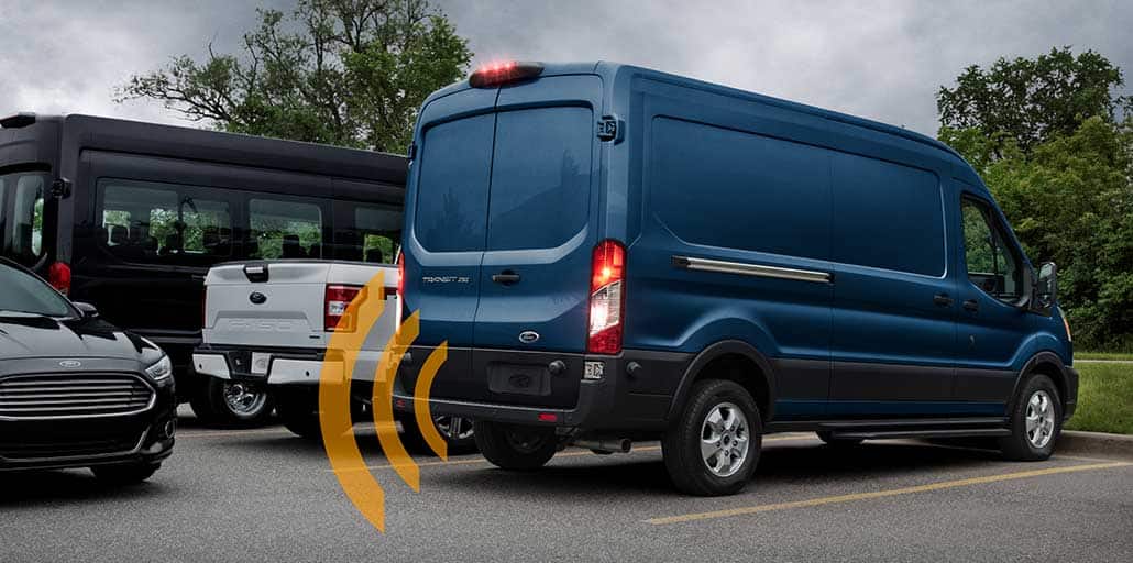 2020 Ford Transit van backing up out of a parking space.