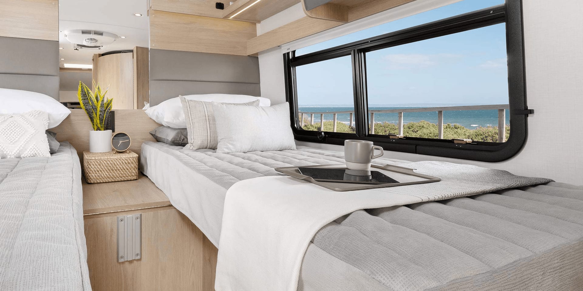 Inside view of an RV showing the made beds.